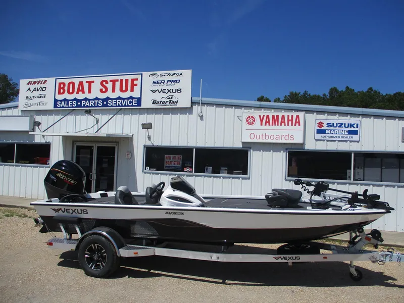 The Image of 2026 Vexus AVX1880 boat on trailer outside dealership with Yamaha and Suzuki signage. - 0