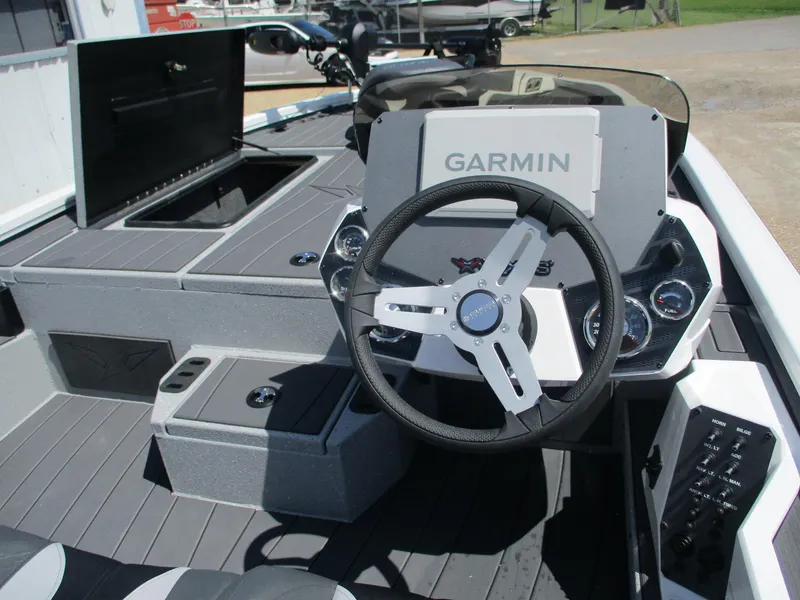 Slide: The Image of 2026 Vexus AVX1880 boat dashboard with Garmin display and steering wheel. - 10