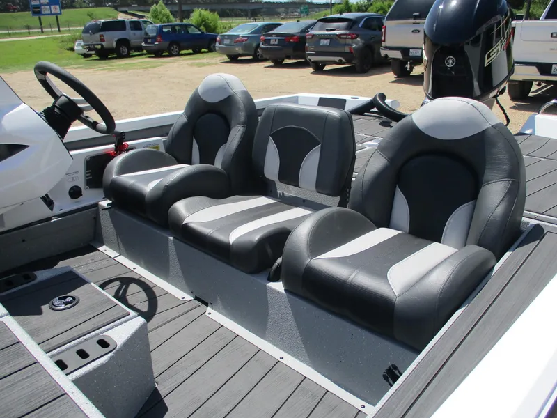 Slide: The Image of 2026 Vexus AVX1880 boat interior with three black and gray seats, steering wheel, and motor. - 11