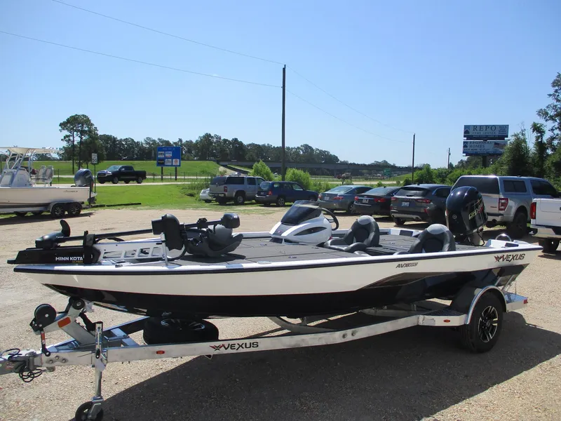 Slide: The Image of 2026 Vexus AVX1880 boat on trailer in parking lot, sunny day. - 2
