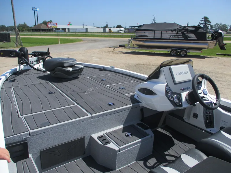 Slide: The Image of 2026 Vexus AVX1880 boat with Garmin system, sleek deck design, and modern steering console. - 5