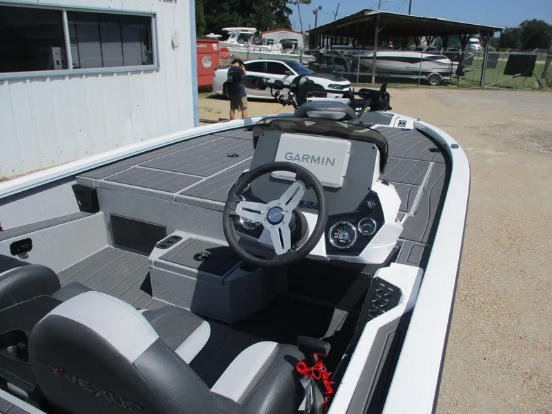 Slide: The Image of 2026 Vexus AVX1880 boat interior with Garmin navigation system and sleek seating. - 7