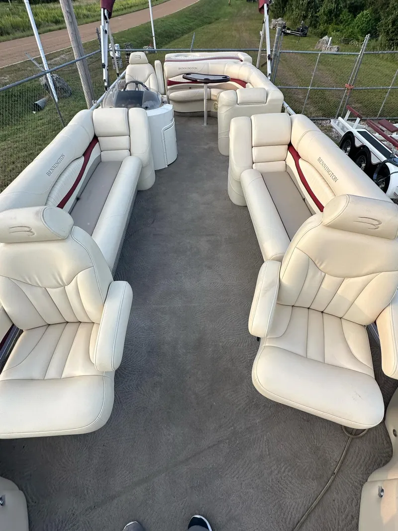 Slide: The Image of 2009 Bennington 2577RFi pontoon boat with spacious seating and beige upholstery. - 2