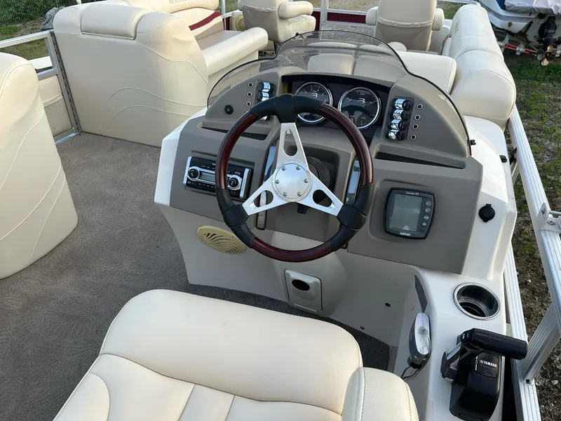Slide: The Image of 2009 Bennington 2577RFi boat dashboard with steering wheel and control panel. - 3