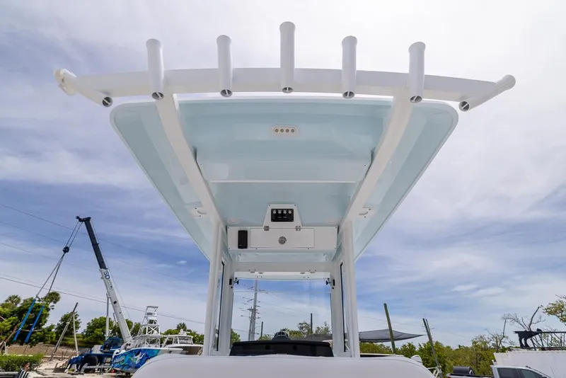 Slide: The Image of 2026 Sea Fox 268 Commander boat top view with rod holders and clear sky background. - 11
