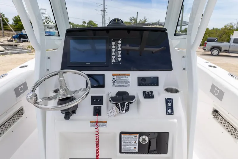 Slide: The Image of 2026 Sea Fox 268 Commander boat dashboard with steering wheel and navigation controls. - 12