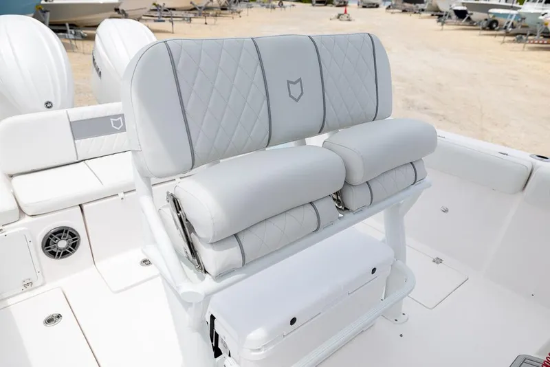 Slide: The Image of 2026 Sea Fox 268 Commander boat seating with quilted upholstery and dual outboard motors. - 15