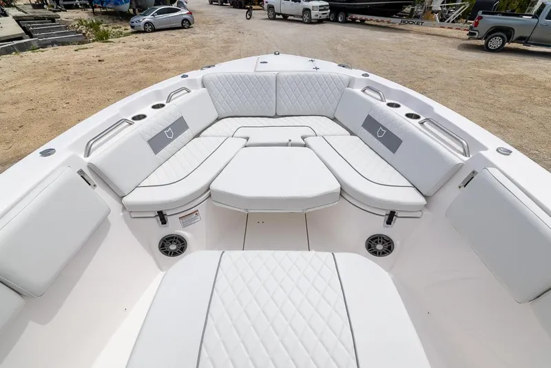Slide: The Image of 2026 Sea Fox 268 Commander boat interior with white cushioned seating and cup holders. - 17