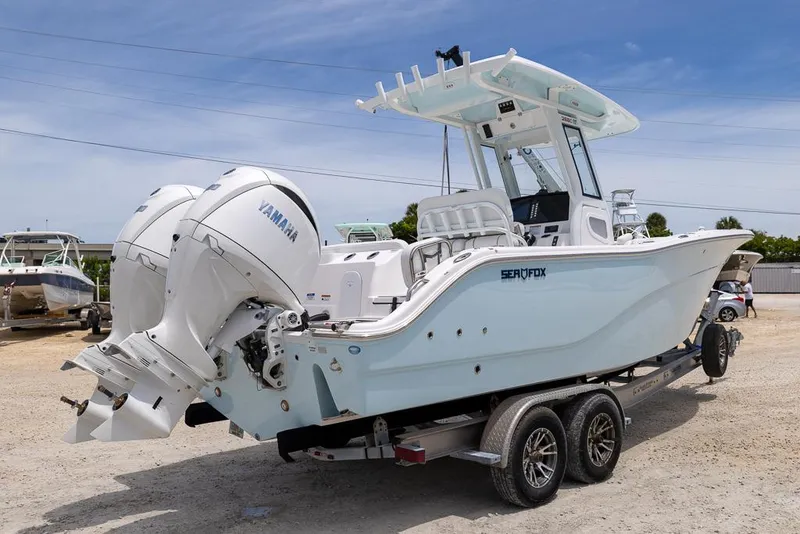 Slide: The Image of 2026 Sea Fox 268 Commander boat with dual Yamaha engines on a trailer. - 2