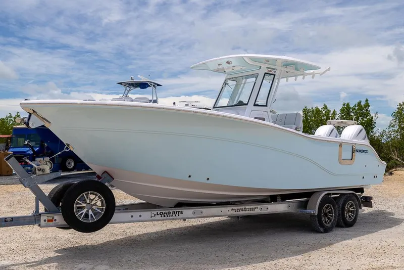 Slide: The Image of 2026 Sea Fox 268 Commander boat on trailer under a cloudy sky. - 6
