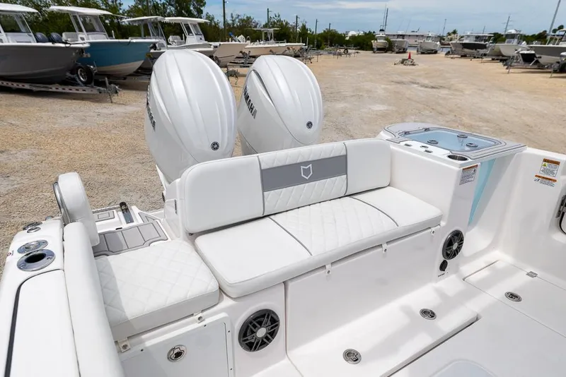 Slide: The Image of 2026 Sea Fox 268 Commander boat with dual Yamaha engines and white seating in a boatyard. - 8