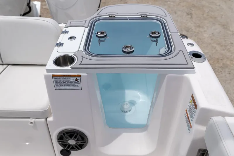 Slide: The Image of Livewell on 2026 Sea Fox 268 Commander boat, featuring cup holder and speaker. - 9