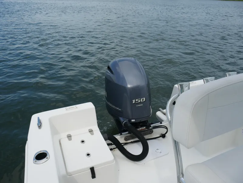Slide: The Image of 2018 KenCraft Challenger 21 boat with Yamaha 150 outboard motor on a calm lake. - 11