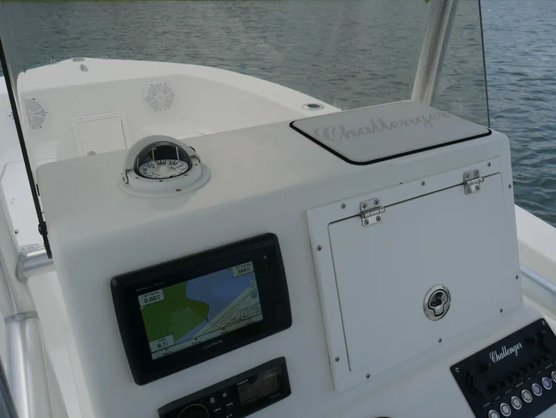 Slide: The Image of 2018 KenCraft Challenger 21 boat dashboard with compass and navigation system. - 12