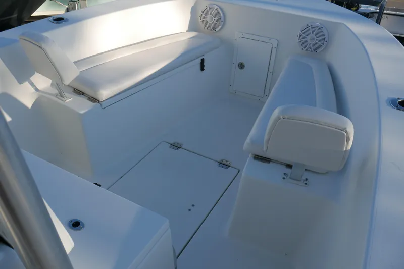 Slide: The Image of 2018 KenCraft Challenger 21 boat interior with white seating and storage compartments. - 18