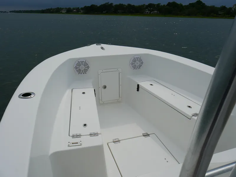 Slide: The Image of 2018 KenCraft Challenger 21 boat console with steering wheel and controls on calm water. - 5