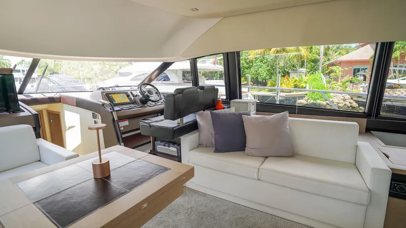 Slide: The Image of Luxurious interior of 2018 Prestige 500 Flybridge yacht with modern seating and navigation area. - 15