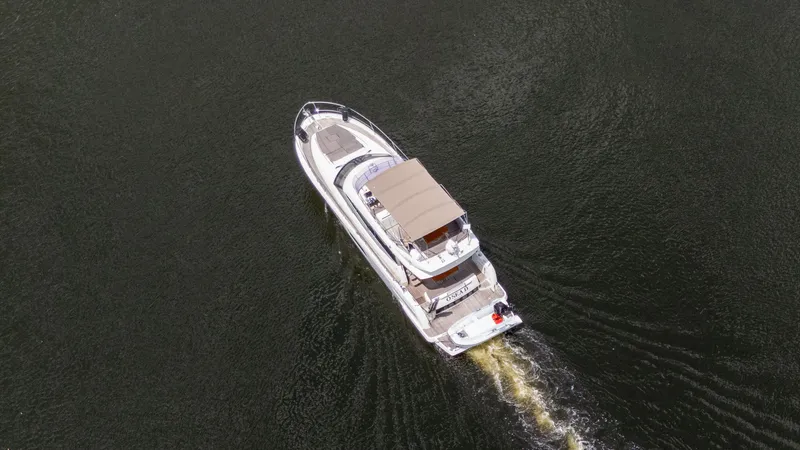 Slide: The Image of Aerial view of 2018 Prestige 500 Flybridge yacht cruising on water. - 6