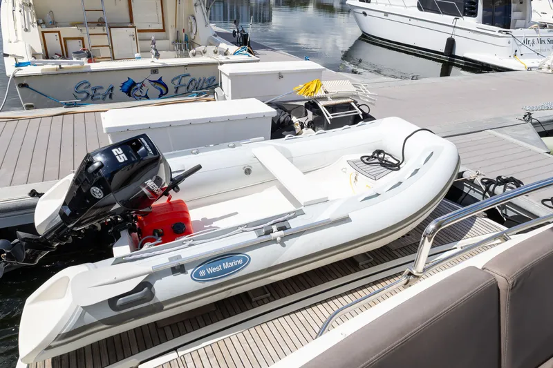 Slide: The Image of Inflatable boat with outboard motor docked beside Prestige 500 Flybridge yacht, 2018 model. - 9