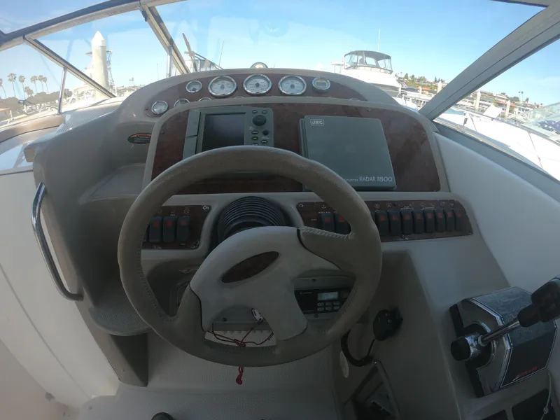 Slide: The Image of 2001 Bayliner 3055 Ciera boat dashboard with steering wheel and navigation instruments. - 11