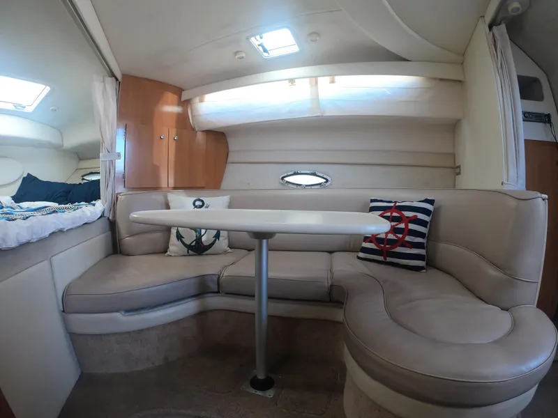 Slide: The Image of Interior of 2001 Bayliner 3055 Ciera with cozy seating and nautical-themed decor. - 17