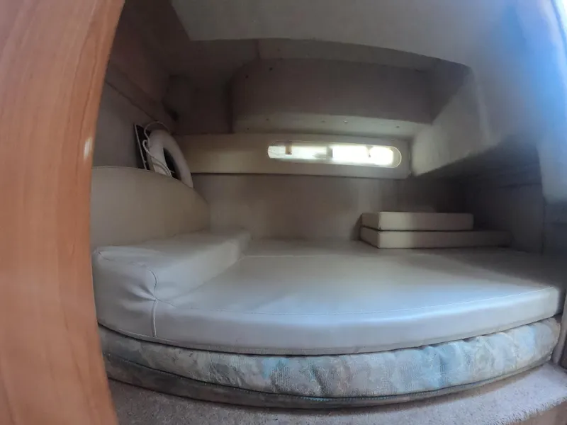 Slide: The Image of 2001 Bayliner 3055 Ciera cabin interior with cushioned seating and small window. - 18