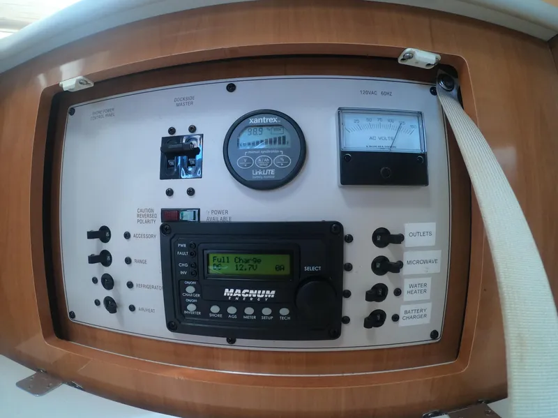 Slide: The Image of Control panel of a 2001 Bayliner 3055 Ciera boat with various gauges and switches. - 19