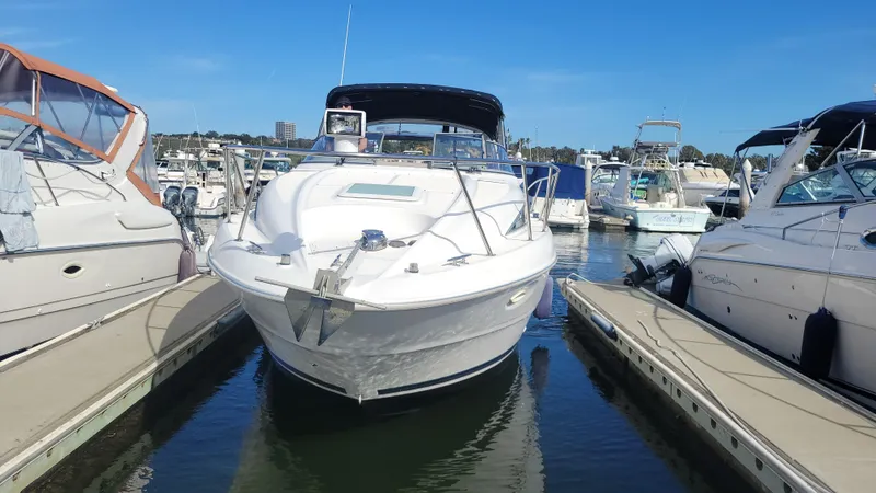 Slide: The Image of 2001 Bayliner 3055 Ciera docked at marina under clear blue sky. - 2
