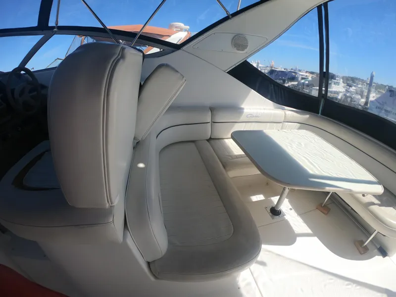 Slide: The Image of 2001 Bayliner 3055 Ciera interior with seating and table, featuring sleek design and ample sunlight. - 6