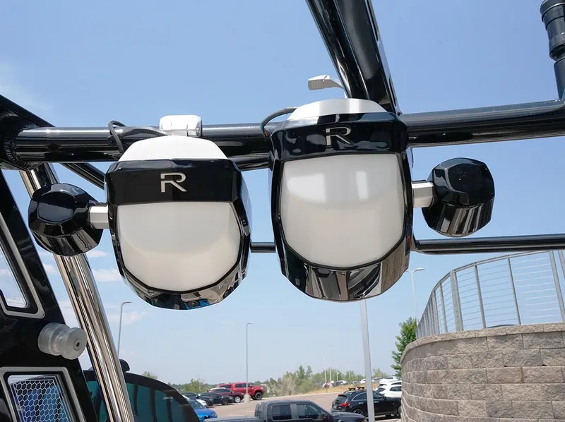Slide: The Image of 2022 Cobalt R6 Surf boat speakers mounted on a sleek black frame under a clear blue sky. - 12
