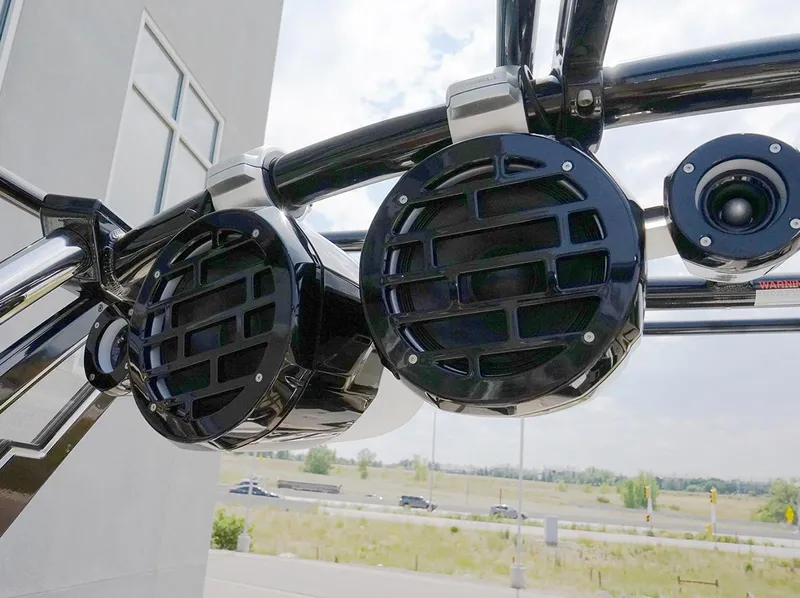 Slide: The Image of Close-up of 2022 Cobalt R6 Surf boat speakers against a clear sky background. - 14