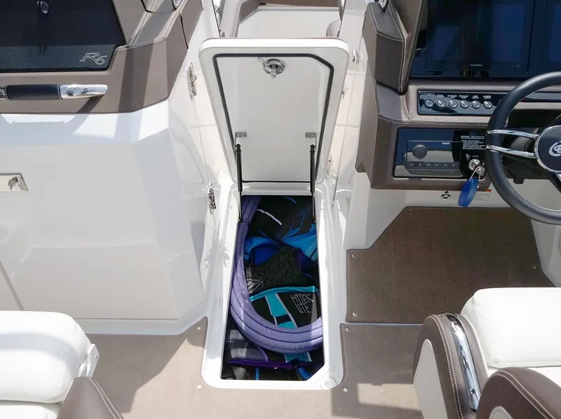 Slide: The Image of 2022 Cobalt R6 Surf boat interior with open storage compartment. - 16
