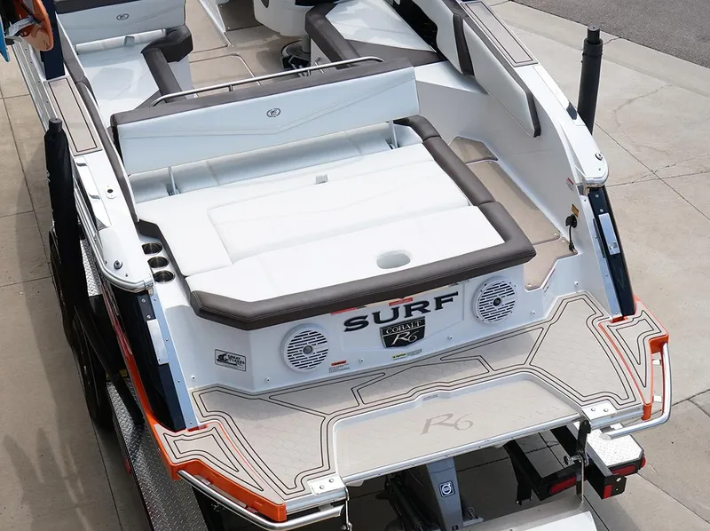 Slide: The Image of 2022 Cobalt R6 Surf boat, rear view, featuring spacious seating and stylish design. - 18
