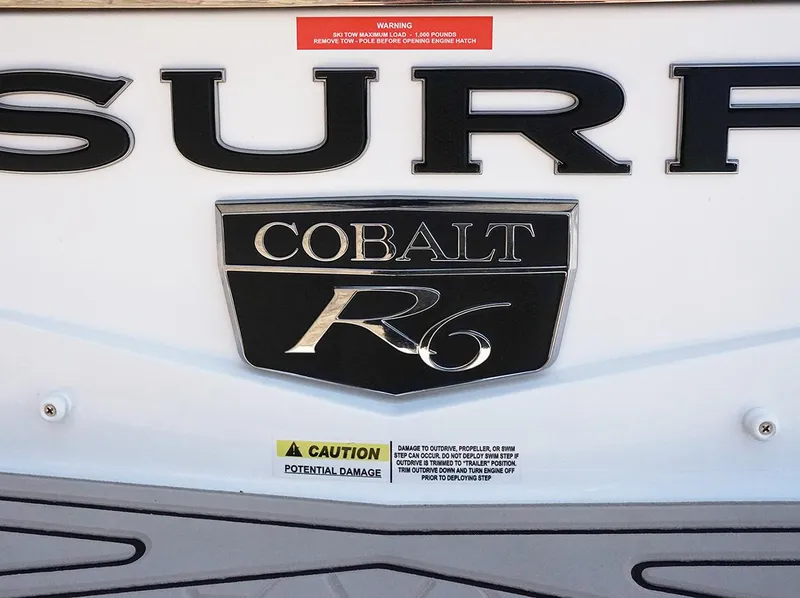 Slide: The Image of 2022 Cobalt R6 Surf boat emblem with caution and warning labels. - 23