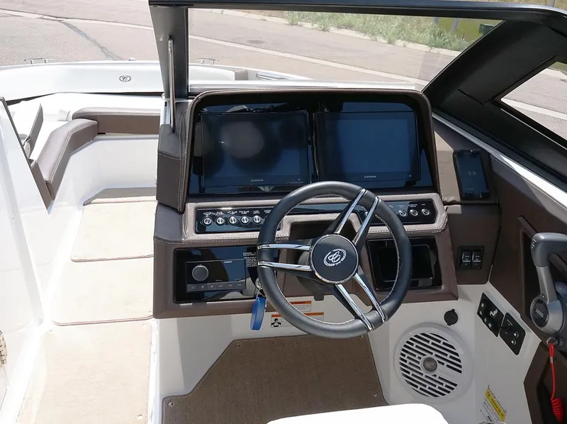 Slide: The Image of 2022 Cobalt R6 Surf boat dashboard with steering wheel and digital displays. - 25