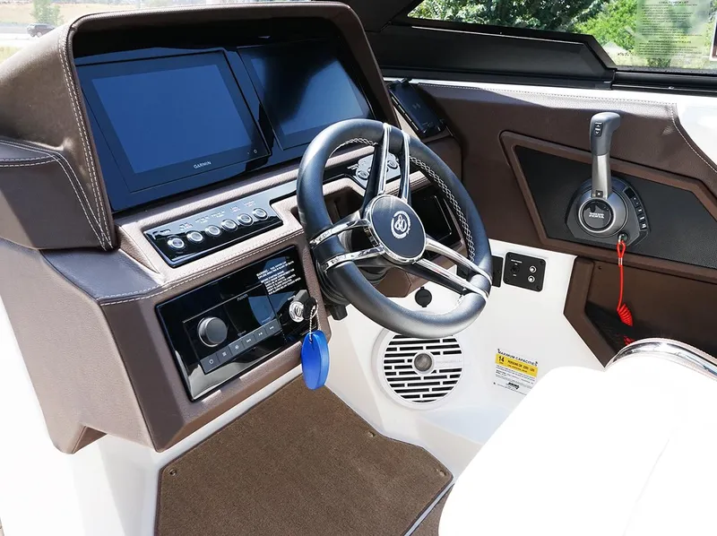 Slide: The Image of 2022 Cobalt R6 Surf boat dashboard with steering wheel and control panel. - 26