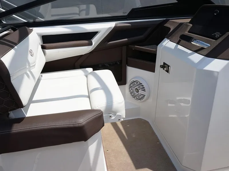 Slide: The Image of 2022 Cobalt R6 Surf boat interior with white and brown seating, speaker, and sleek design. - 30
