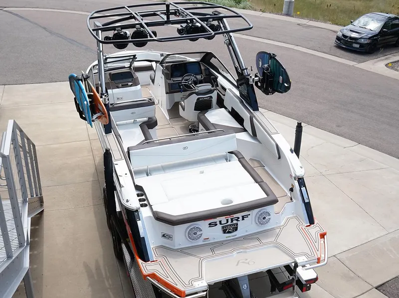 Slide: The Image of 2022 Cobalt R6 Surf boat with sleek interior and advanced features, parked on concrete. - 8