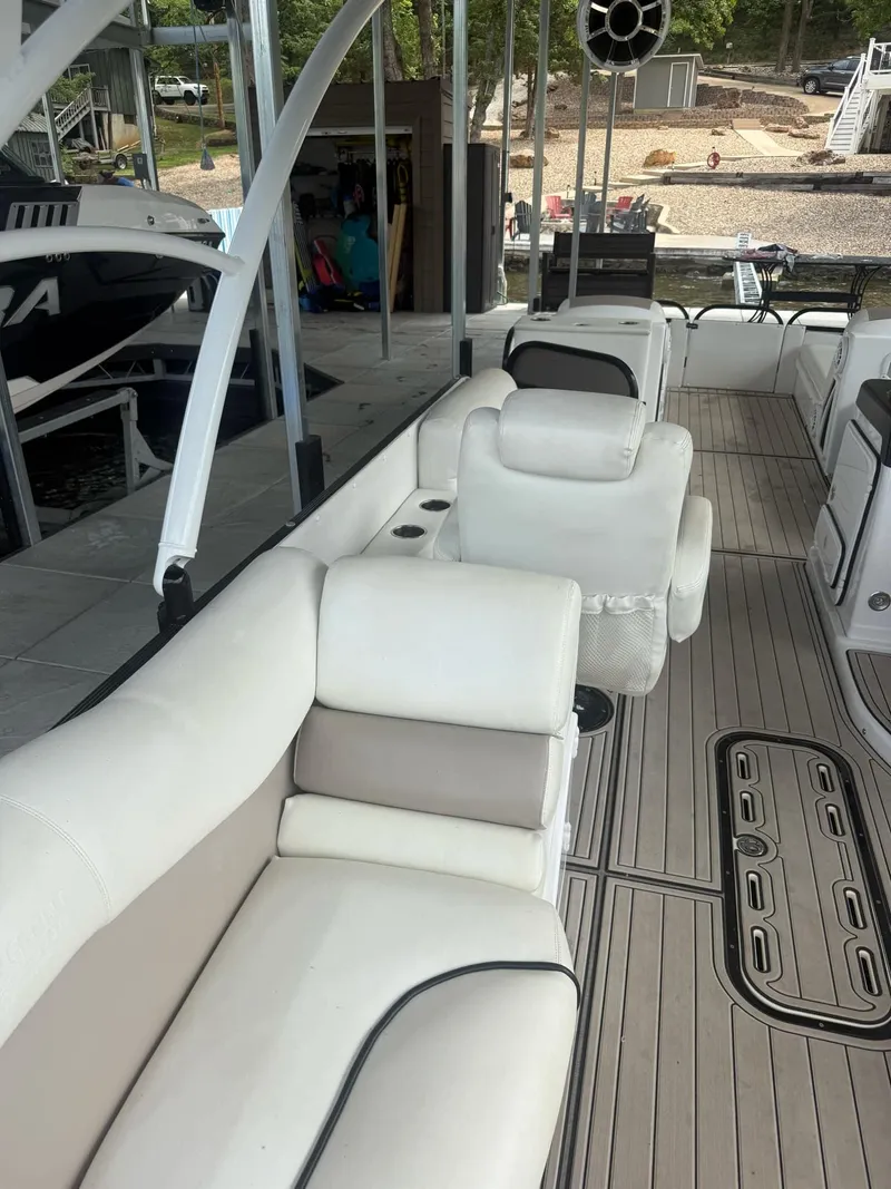 Slide: The Image of 2019 PlayCraft 29 Infinity boat interior with white seating and wood-style flooring. - 4