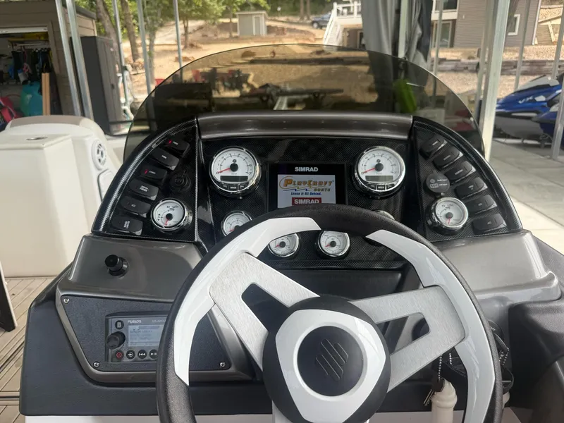 Slide: The Image of Control panel of a 2019 PlayCraft 29 Infinity boat with steering wheel and gauges. - 5