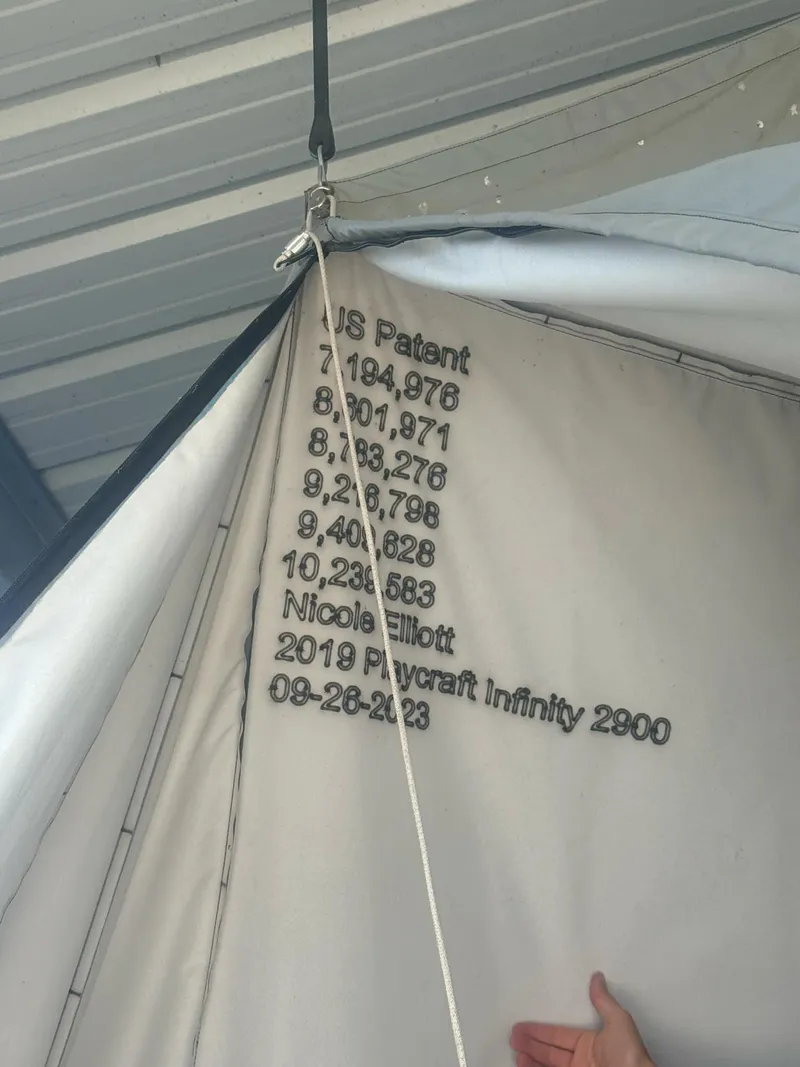 Slide: The Image of 2019 PlayCraft Infinity 29 boat cover with patent numbers and date, hanging in a garage. - 6