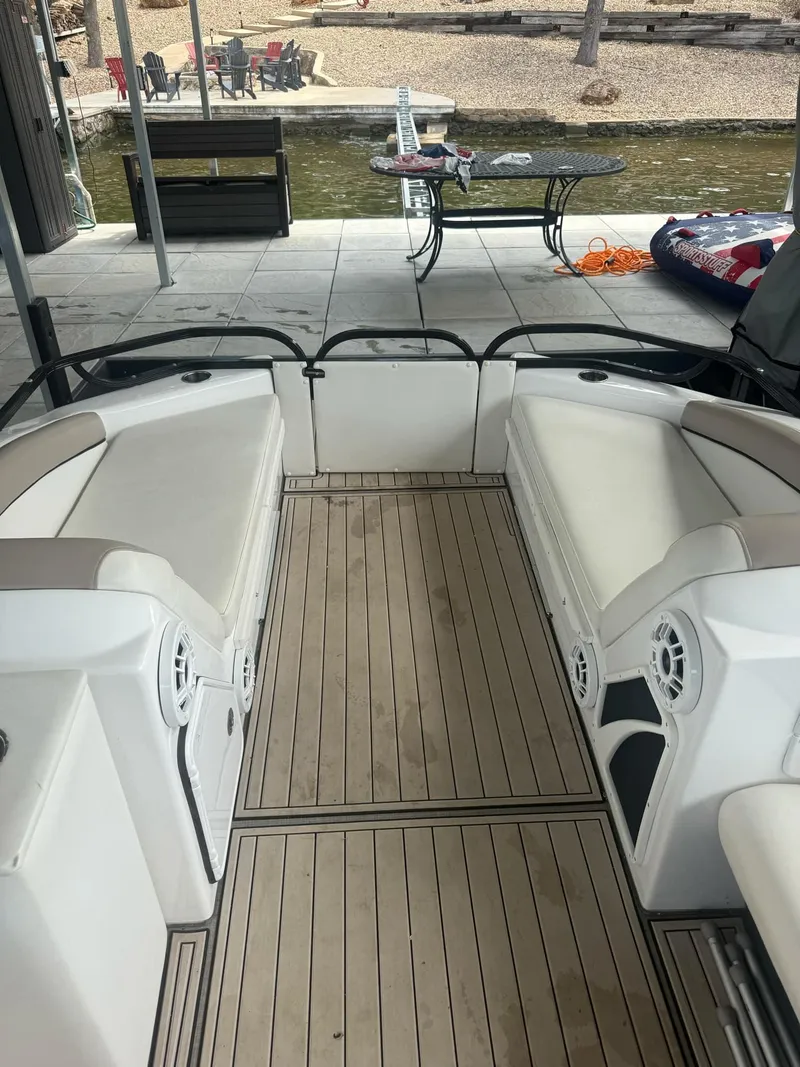 Slide: The Image of 2019 PlayCraft 29 Infinity boat interior with cushioned seating and wood-style flooring. - 8