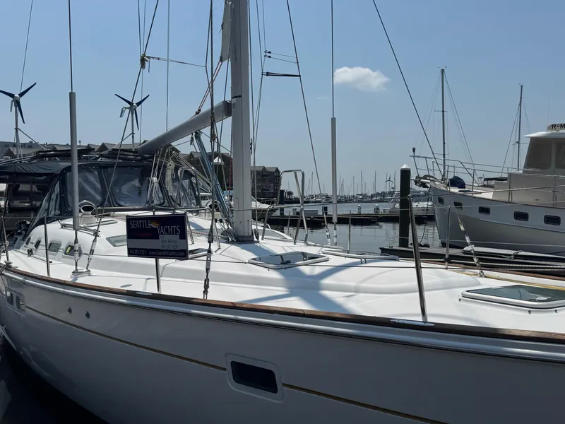 Slide: The Image of 2005 Beneteau Oceanis Clipper 473 yacht docked at marina, clear sky background. - 10