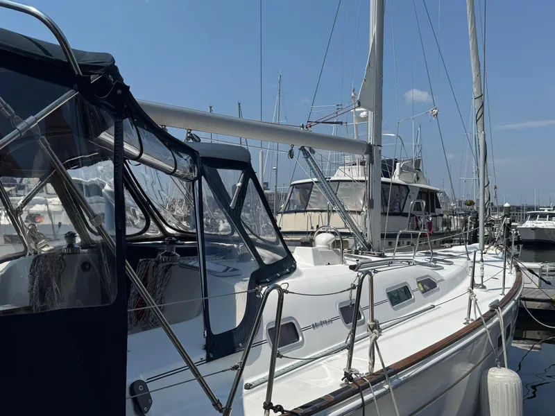 Slide: The Image of 2005 Beneteau Oceanis Clipper 473 sailboat docked at marina under clear blue sky. - 12
