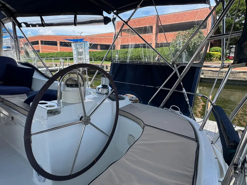Slide: The Image of 2005 Beneteau Oceanis Clipper 473 yacht cockpit with steering wheel and seating area. - 17