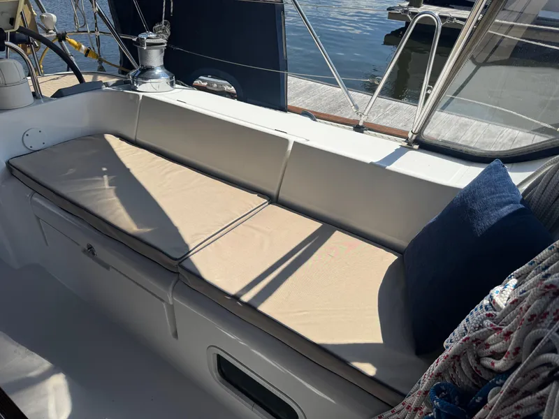 Slide: The Image of Beneteau Oceanis Clipper 473 cockpit with cushioned seating, ropes, and water view. - 19
