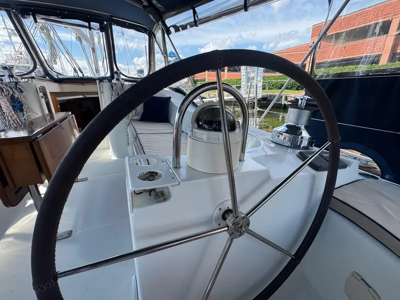 Slide: The Image of Steering wheel of 2005 Beneteau Oceanis Clipper 473 sailboat, docked with clear skies. - 24
