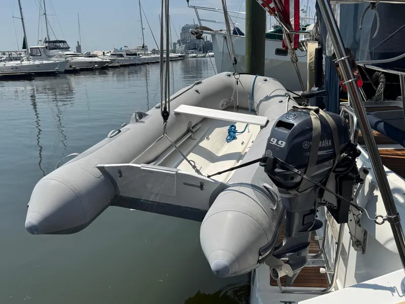 Slide: The Image of Inflatable dinghy with Yamaha 9.9 motor on Beneteau Oceanis Clipper 473, 2005 model, docked. - 26