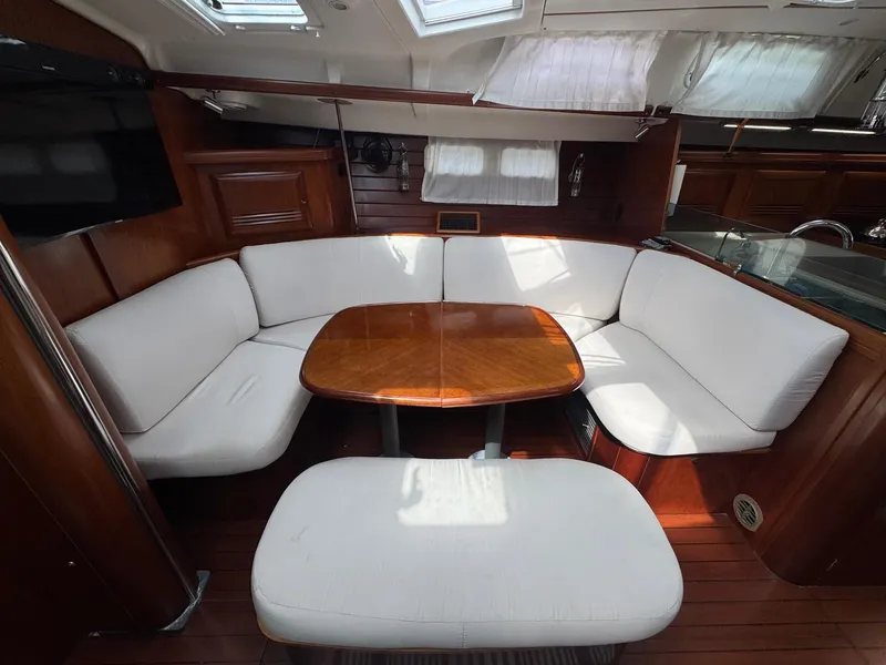 Slide: The Image of Interior of 2005 Beneteau Oceanis Clipper 473 yacht with cozy seating and wooden table. - 33