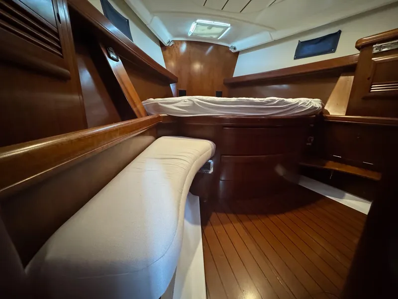 Slide: The Image of Interior of 2005 Beneteau Oceanis Clipper 473 yacht with wooden finish and cozy bed. - 47
